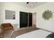 Bedroom with hardwood flooring, a modern decor, and sleek black closet doors at 205 Gentry St, Roxboro, NC 27573