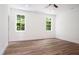 Bright bedroom with two windows and wood flooring at 205 Gentry St, Roxboro, NC 27573