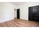 A bright bedroom with wood floors and black paneled doors and white trim accents at 205 Gentry St, Roxboro, NC 27573