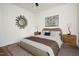 Bright bedroom complete with stylish decor, hardwood floors, and a ceiling fan at 205 Gentry St, Roxboro, NC 27573