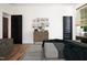 Decorated bedroom showcasing wood floors, dark doors, and a window at 205 Gentry St, Roxboro, NC 27573