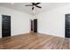 Spacious room with wood floors, featuring natural light and dark doors at 205 Gentry St, Roxboro, NC 27573