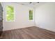 Empty bedroom with hardwood flooring and natural light from its many windows at 205 Gentry St, Roxboro, NC 27573