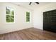 Bright bedroom featuring sleek hardwood flooring and natural light through two windows at 205 Gentry St, Roxboro, NC 27573