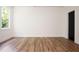 This well lit bedroom offers hardwood flooring and a door leading outside at 205 Gentry St, Roxboro, NC 27573