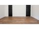 Bright room with wood flooring, white walls, trim and black doors adds a modern touch at 205 Gentry St, Roxboro, NC 27573
