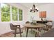Charming dining area with rustic table and chairs, a stylish chandelier, and wall art adding character at 205 Gentry St, Roxboro, NC 27573