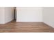 Spacious, empty room shows the lovely wood laminate flooring and crisp white baseboards at 205 Gentry St, Roxboro, NC 27573