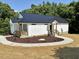 Attractive white home with black roof, showcasing well-kept landscaping, and a welcoming entrance at 205 Gentry St, Roxboro, NC 27573
