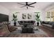 Relaxing living room with modern decor, sleek wood flooring, a ceiling fan, and lots of natural light at 205 Gentry St, Roxboro, NC 27573