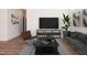 Comfortable living room area with a large television and stylish furniture, showcasing a modern aesthetic at 205 Gentry St, Roxboro, NC 27573