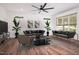 Modern living room featuring lots of seating, sleek wood flooring, a ceiling fan, and natural light at 205 Gentry St, Roxboro, NC 27573