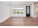 Well-lit living room featuring sleek wood floors, a modern ceiling fan, and a view to the exterior at 205 Gentry St, Roxboro, NC 27573