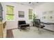 Well-lit office with a ceiling fan, stylish chair, desk, and an outdoor view at 205 Gentry St, Roxboro, NC 27573
