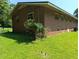 Exterior view from yard, highlighting brick facade and natural light from multiple windows at 2306 Cool Springs Rd, Sanford, NC 27330