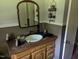 Bathroom vanity with wooden cabinets and mirror at 2306 Cool Springs Rd, Sanford, NC 27330