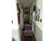 Hallway with hardwood floors, neutral walls, and decorative wall art throughout at 2306 Cool Springs Rd, Sanford, NC 27330