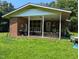 Welcoming front porch with brick accents, offering a cozy outdoor space with potential for customization at 2306 Cool Springs Rd, Sanford, NC 27330