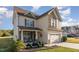 Charming two-story home with stone accents, covered front porch and a two-car garage at 2407 Cattail Pond Dr, Zebulon, NC 27597