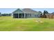 Backyard view of house with screen porch, spacious lawn and landscaping, showing the home's outdoor appeal at 25 Harlow Ct, Fuquay Varina, NC 27526