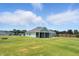 Expansive backyard view with a well-maintained lawn, showcasing the home's outdoor space, firepit, and privacy at 25 Harlow Ct, Fuquay Varina, NC 27526