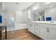 Bright bathroom featuring a glass shower, soaking tub, double vanity, and modern fixtures at 25 Harlow Ct, Fuquay Varina, NC 27526