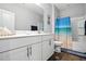 Bright bathroom featuring a white vanity with granite countertop and a bathtub with blue ocean-themed shower curtain at 25 Harlow Ct, Fuquay Varina, NC 27526