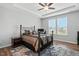 Comfortable bedroom with a tray ceiling, large windows, and modern decor at 25 Harlow Ct, Fuquay Varina, NC 27526