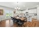 An open floor plan that features a modern kitchen next to a large dining room table and chairs at 25 Harlow Ct, Fuquay Varina, NC 27526