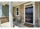 Inviting front porch with stone accents, seating, and a stylish black front door at 25 Harlow Ct, Fuquay Varina, NC 27526