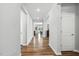 Bright hallway with hardwood floors leading to an open-concept living area at 25 Harlow Ct, Fuquay Varina, NC 27526