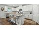 Modern kitchen with white cabinets, granite countertops, stainless steel appliances, and bar stool seating at 25 Harlow Ct, Fuquay Varina, NC 27526