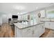 Bright, open kitchen featuring a large island, granite countertops, and stainless steel appliances at 25 Harlow Ct, Fuquay Varina, NC 27526