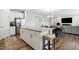 Spacious kitchen with a granite island, stainless steel refrigerator, and an open layout to the living area at 25 Harlow Ct, Fuquay Varina, NC 27526