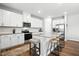 Modern kitchen with white cabinets, granite countertops, stainless steel appliances, and a large island at 25 Harlow Ct, Fuquay Varina, NC 27526