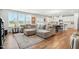 Open-concept living room featuring a large sectional sofa, hardwood floors, and a view into the kitchen at 25 Harlow Ct, Fuquay Varina, NC 27526
