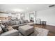 Spacious living room with an open floor plan connecting to a modern white kitchen at 25 Harlow Ct, Fuquay Varina, NC 27526
