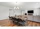 Open-concept living and dining area with modern decor, wood flooring, and ample natural light at 25 Harlow Ct, Fuquay Varina, NC 27526