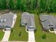 Stunning aerial view of a modern home with manicured landscaping and a long driveway at 2511 Range Overlook Xing, Apex, NC 27523