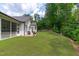 Spacious backyard with lush green lawn and mature trees, perfect for outdoor activities at 2511 Range Overlook Xing, Apex, NC 27523