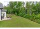 Expansive backyard with lush green lawn, mature trees, and a serene natural setting at 2511 Range Overlook Xing, Apex, NC 27523