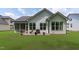 Well-maintained backyard featuring a lush lawn, a patio with seating, and mature landscaping at 2511 Range Overlook Xing, Apex, NC 27523
