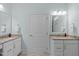 Well-lit bathroom featuring dual sinks with granite countertops and modern fixtures at 2511 Range Overlook Xing, Apex, NC 27523