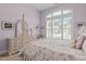 Comfortable bedroom featuring a four-poster bed, arched windows, and ample natural light at 2511 Range Overlook Xing, Apex, NC 27523