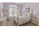 Comfortable bedroom featuring a four-poster bed, arched windows, and ample natural light at 2511 Range Overlook Xing, Apex, NC 27523