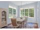 Charming dining room with large windows, a stylish chandelier, and ample natural light at 2511 Range Overlook Xing, Apex, NC 27523