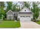 Charming home featuring a stone and white exterior, well-manicured lawn, and a two-car garage at 2511 Range Overlook Xing, Apex, NC 27523