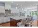 Bright kitchen featuring a center island with seating, stainless steel appliances, and modern lighting at 2511 Range Overlook Xing, Apex, NC 27523