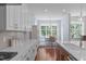 Open-concept kitchen with modern appliances, white cabinetry, and an adjacent dining area at 2511 Range Overlook Xing, Apex, NC 27523