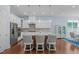 Modern kitchen with white cabinets, stainless steel appliances, and a stylish center island with seating at 2511 Range Overlook Xing, Apex, NC 27523
